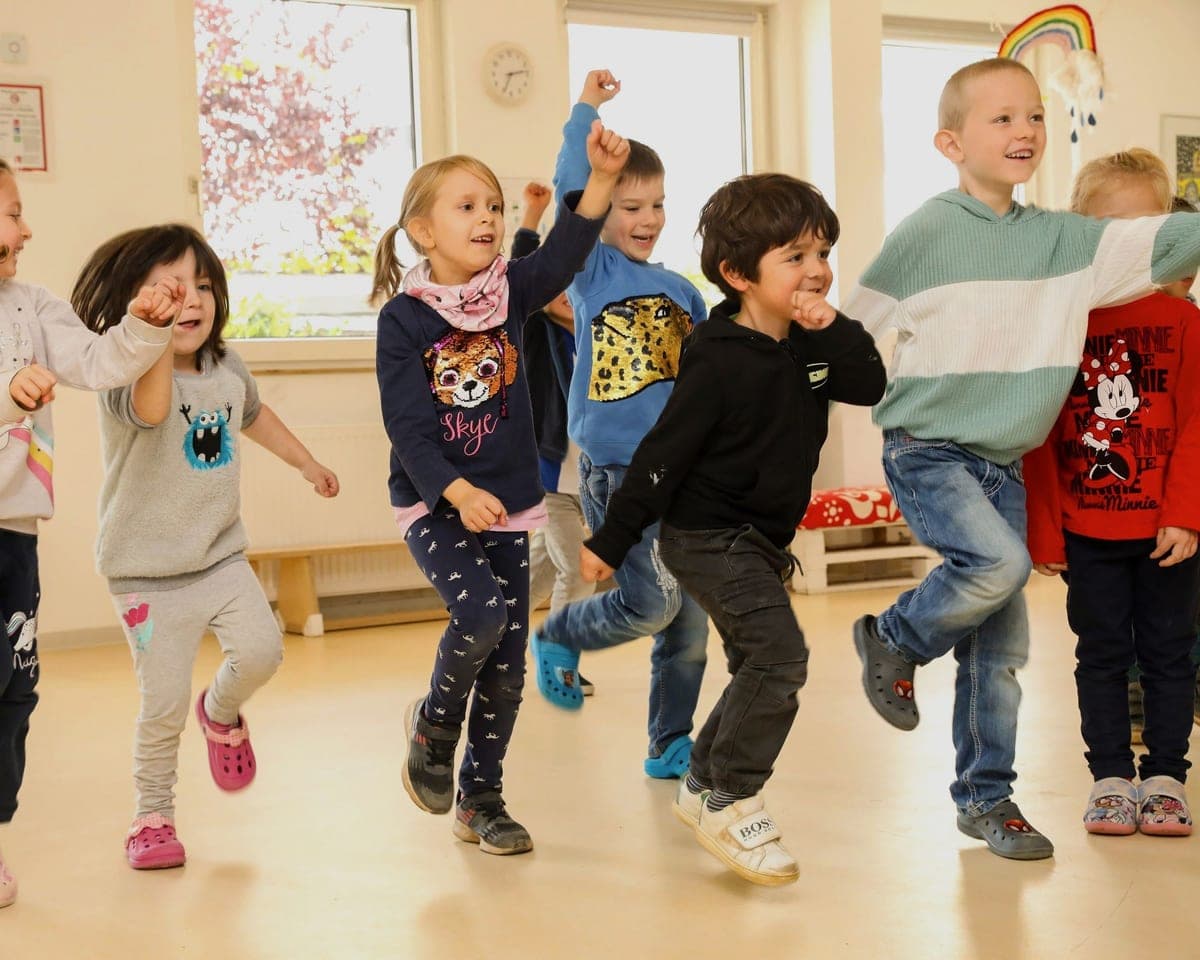FitScouts-Kindergarten Wiesbaden: Kindergruppe tanzt ausgelassen im Bewegungsraum